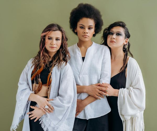 Group of diverse women practicing yoga together in a modern studio.